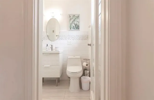 a bathroom with a toilet sink and mirror