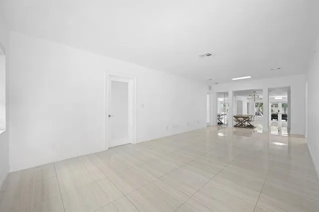 a view of an empty room with glass door