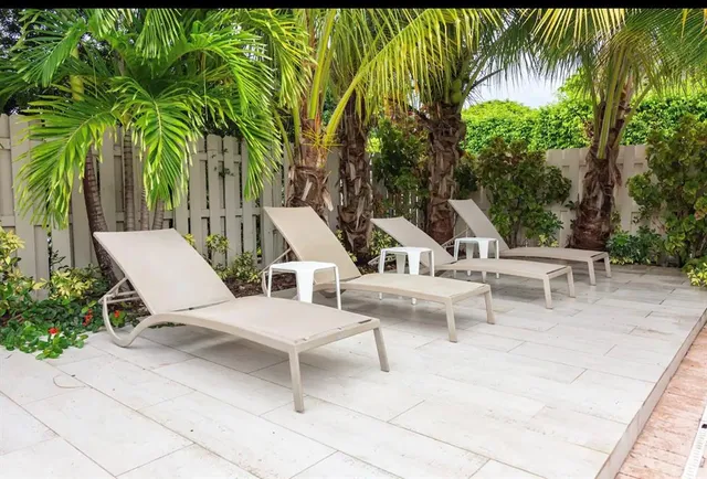 a view of two chairs and a table in a patio