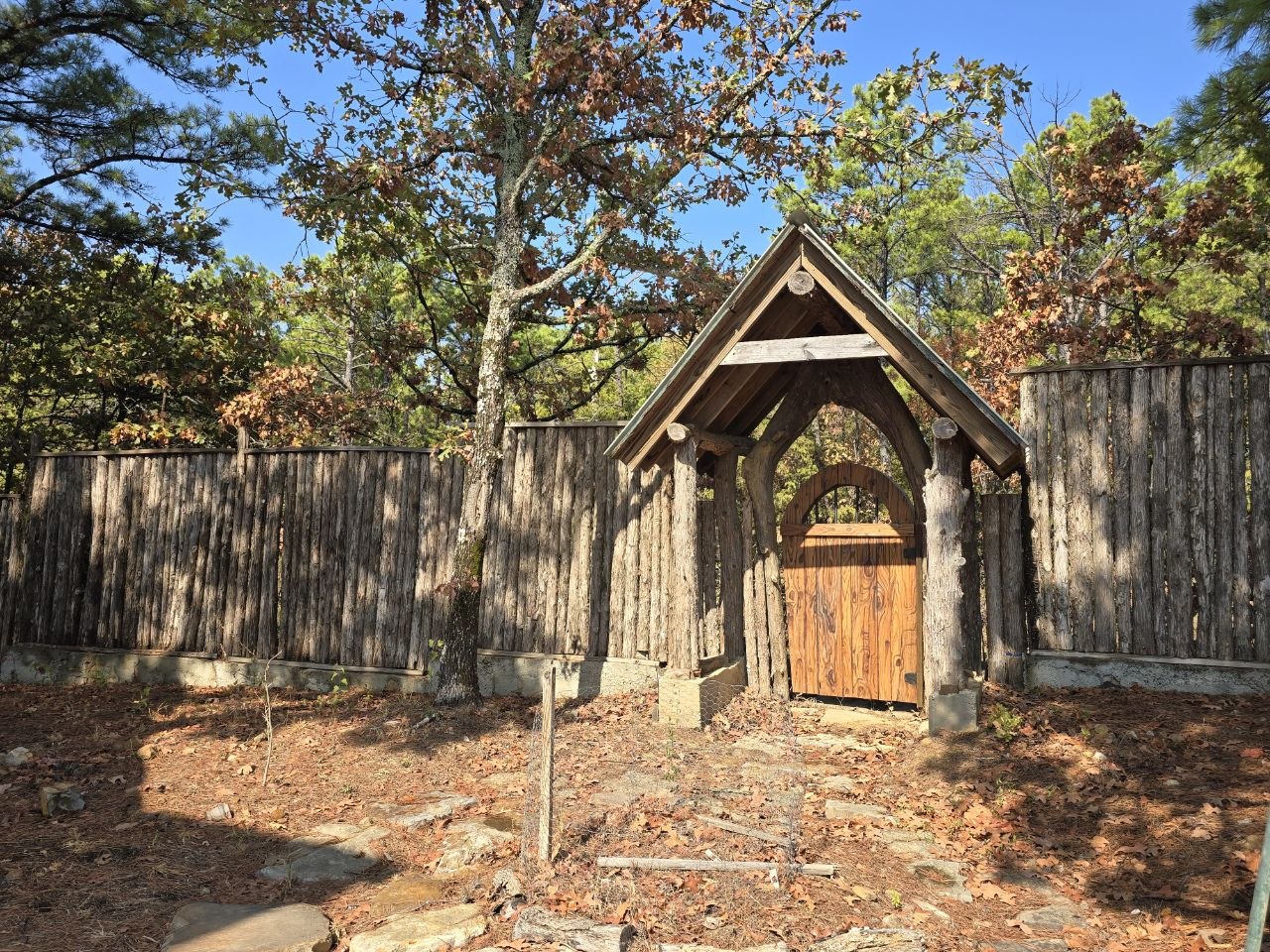 1097 Flagpole Road Clayton, OK 74536 - Photo 25 of 32 Wood picket fence with a built-in wooden gate and archway
