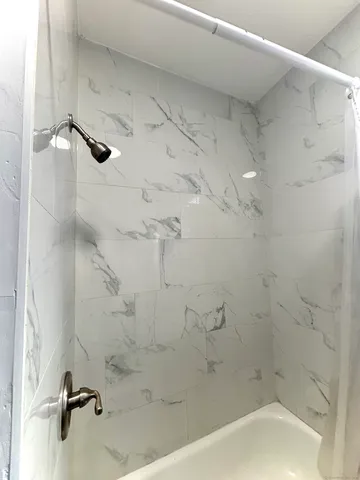 a bath tub sitting next to a white sink