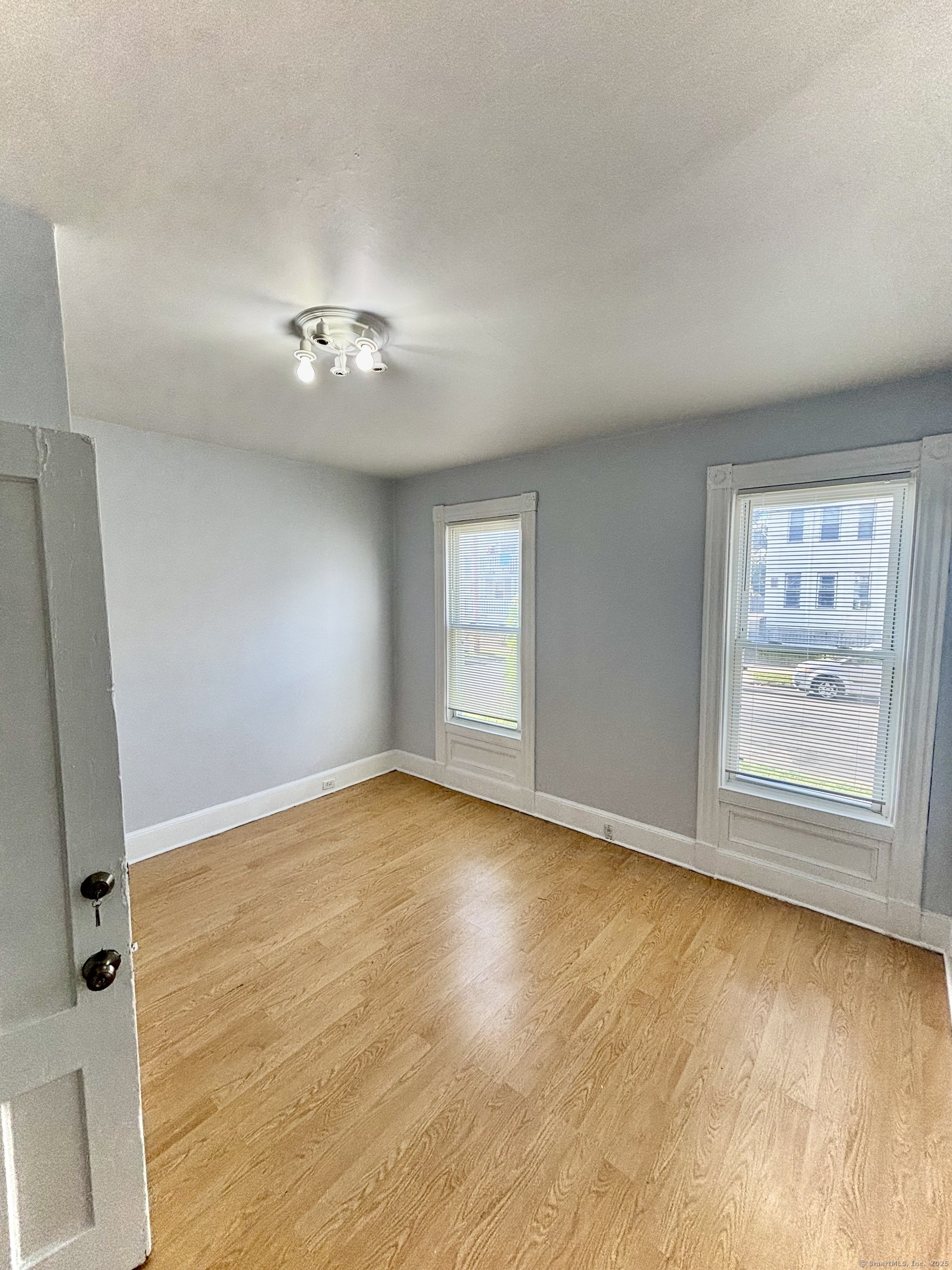 57 Houston Street, Unit 1 New Haven, CT 06513 - Photo 7 of 11 wooden floor in an empty room with a window