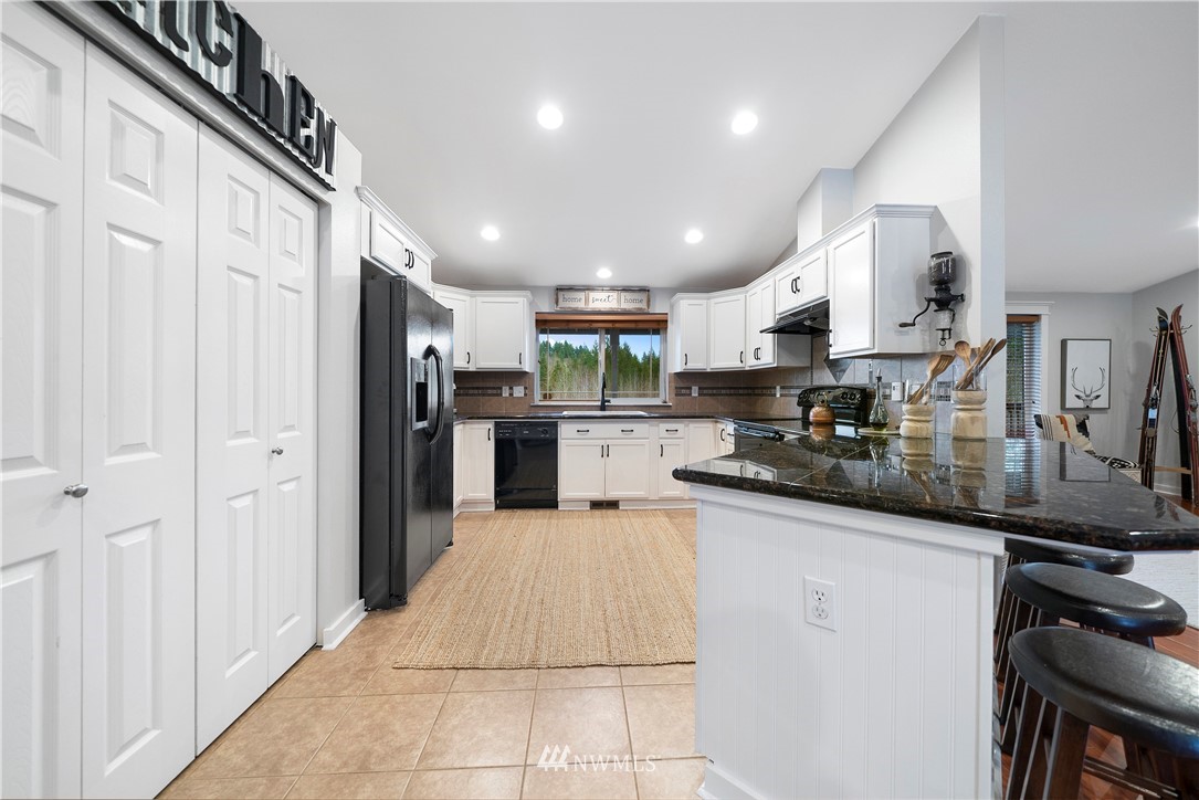 14817 South Tilley Road Tenino, WA 98589 - Photo 13 of 38 a kitchen with stainless steel appliances granite countertop a refrigerator and a sink