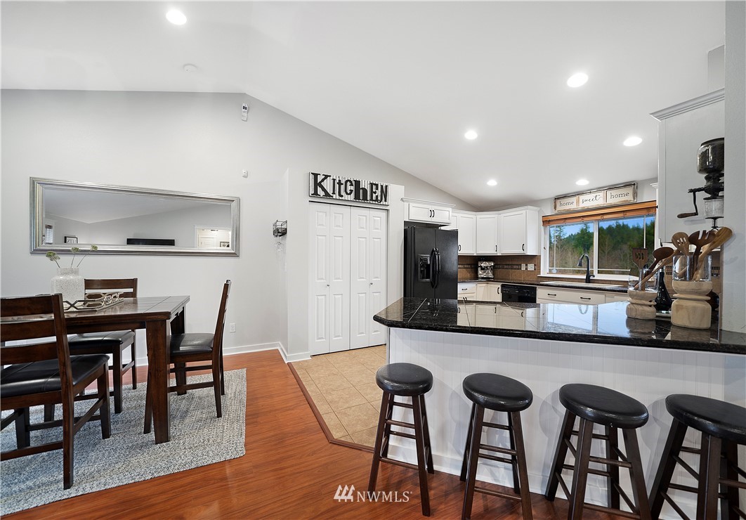 14817 South Tilley Road Tenino, WA 98589 - Photo 14 of 38 a kitchen with stainless steel appliances kitchen island granite countertop a dining table chairs and a oven
