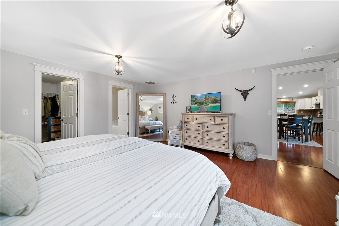 14817 South Tilley Road Tenino, WA 98589 - Photo 18 of 38 a bedroom with a bed and a chandelier