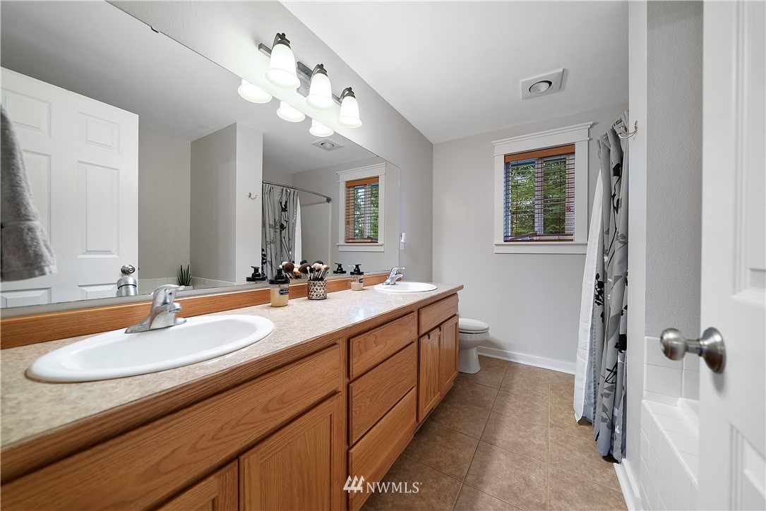 14817 South Tilley Road Tenino, WA 98589 - Photo 19 of 38 a bathroom with a sink double vanity granite tub and a mirror