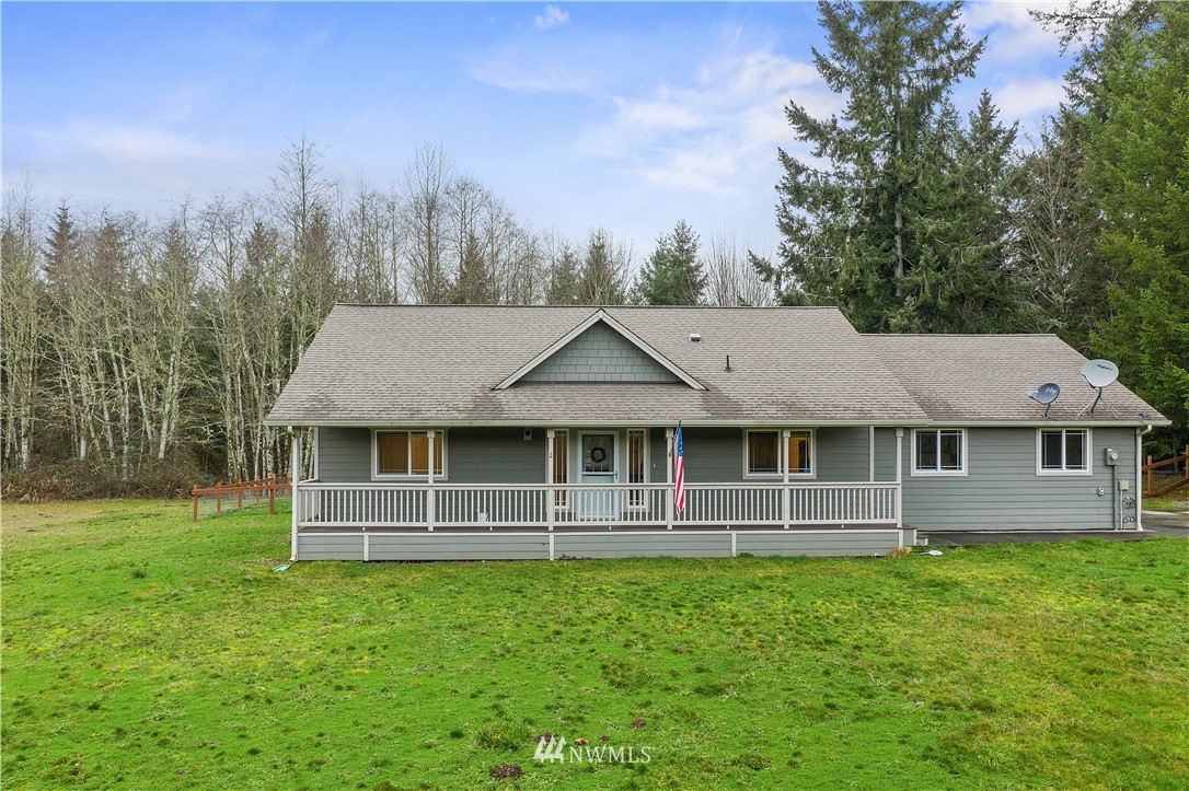 14817 South Tilley Road Tenino, WA 98589 - Photo 3 of 38 a front view of a house with a garden and trees
