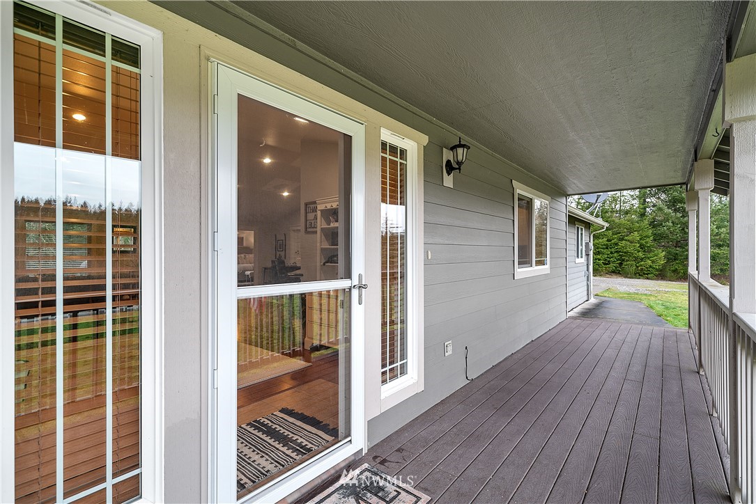 14817 South Tilley Road Tenino, WA 98589 - Photo 4 of 38 a view of backyard with large window and wooden floor