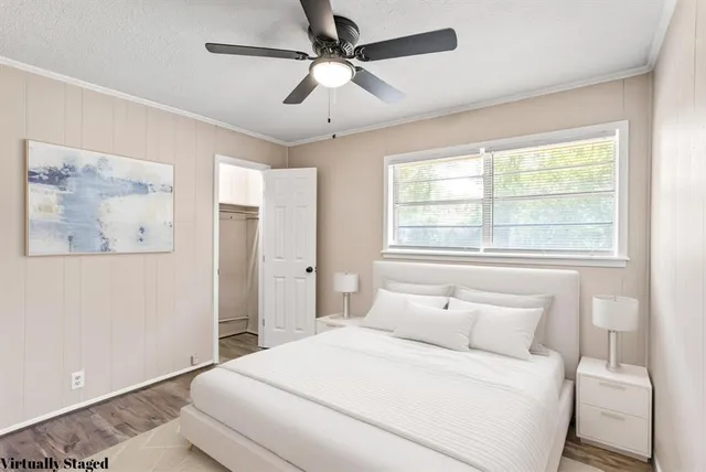 a bedroom with a large bed and a window