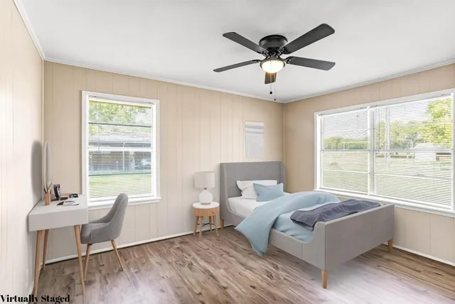 a living room with a bed furniture and a window