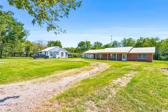a house with swimming pool in front of it