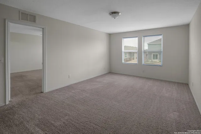 a view of an empty room with a window