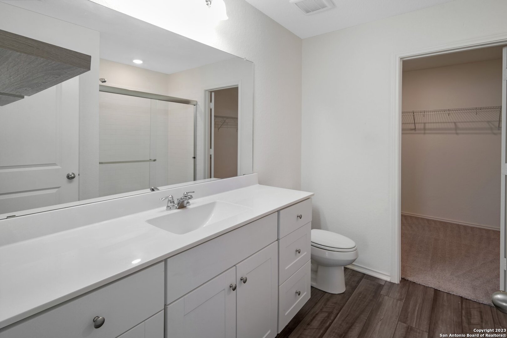 5246 Winding Streme St. Hedwig, TX 78152 - Photo 16 of 25 a bathroom with a sink a toilet a shower and a mirror
