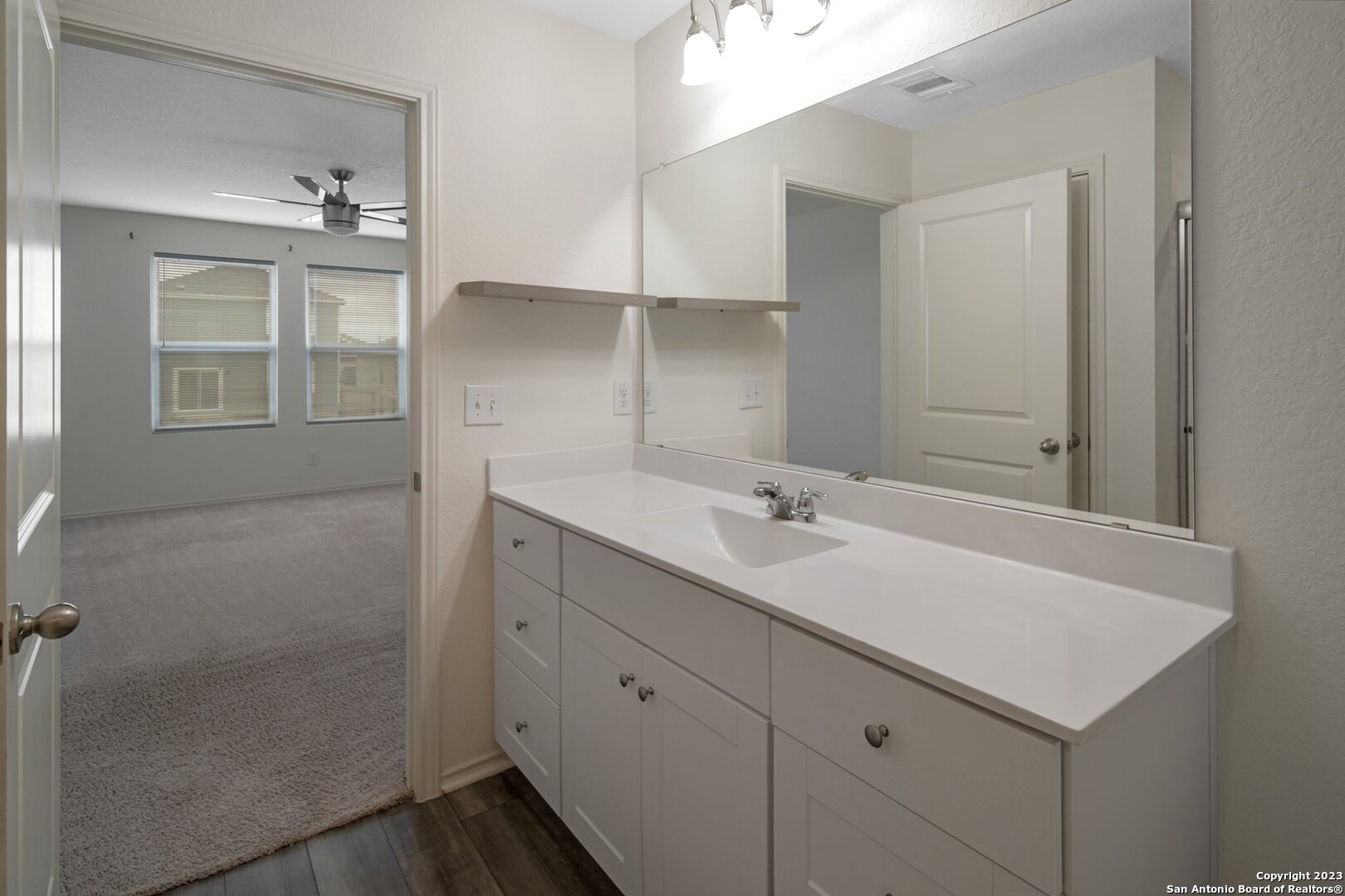 5246 Winding Streme St. Hedwig, TX 78152 - Photo 17 of 25 a bathroom with a sink shower and a mirror