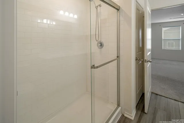 a bathroom with a glass shower door