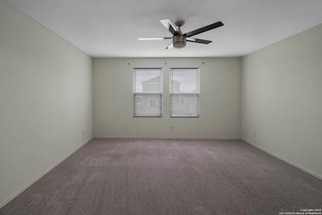 an empty room with a empty space and windows