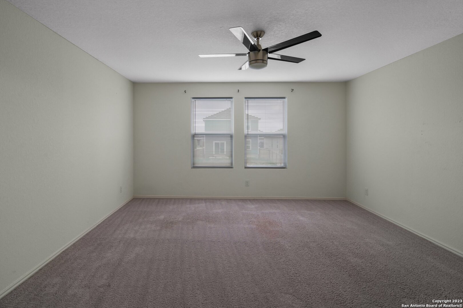 5246 Winding Streme St. Hedwig, TX 78152 - Photo 20 of 25 an empty room with a empty space and windows