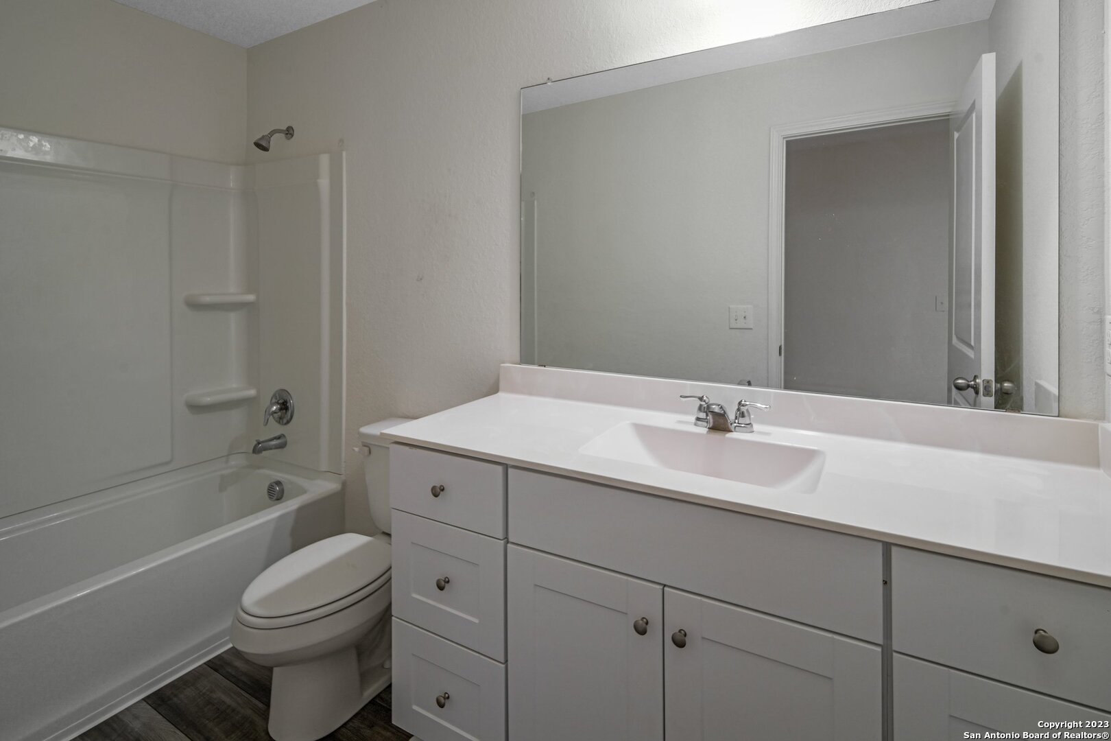 5246 Winding Streme St. Hedwig, TX 78152 - Photo 22 of 25 a bathroom with a granite countertop toilet a sink and a bathtub