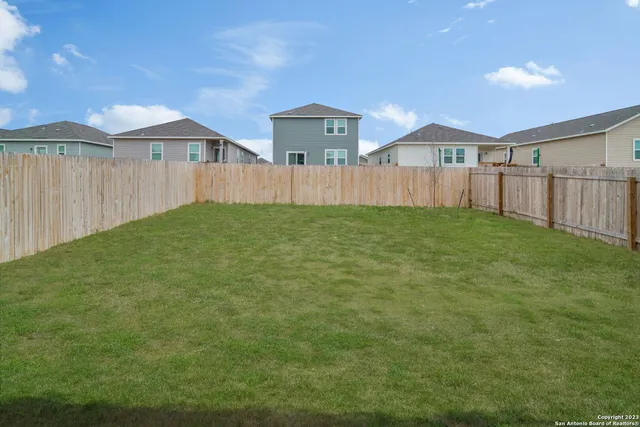 a view of a backyard of the house