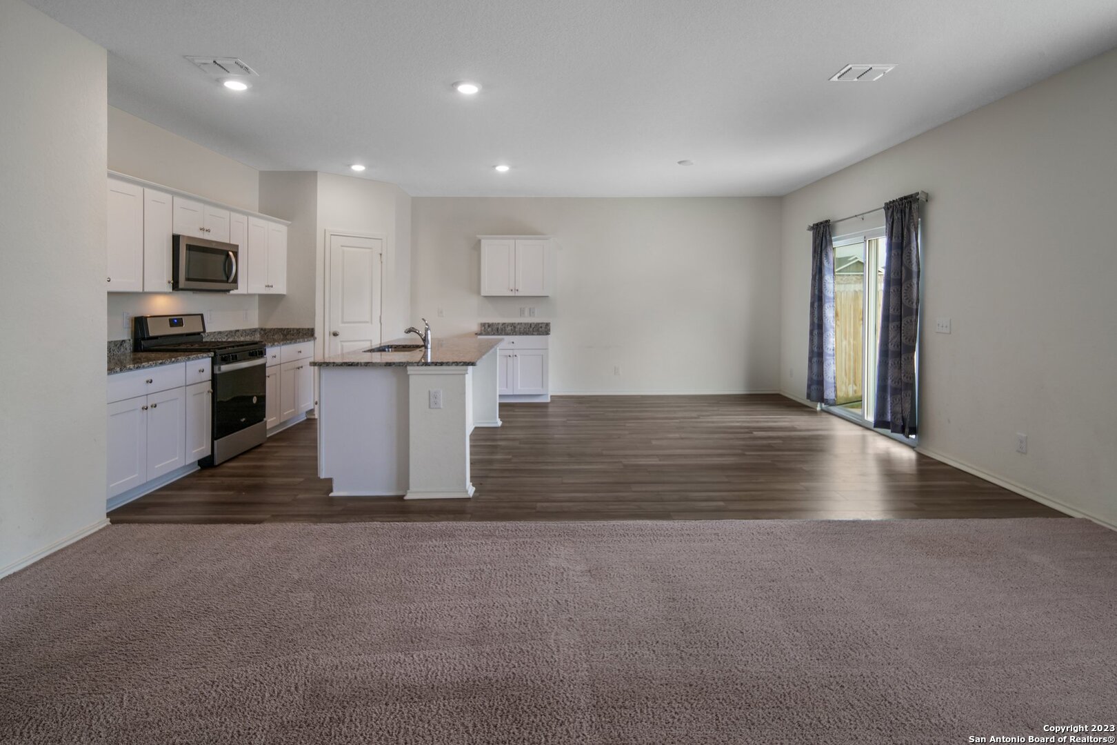 5246 Winding Streme St. Hedwig, TX 78152 - Photo 3 of 25 a view of kitchen with microwave stove refrigerator and cabinets