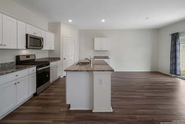 a kitchen with a sink and cabinets