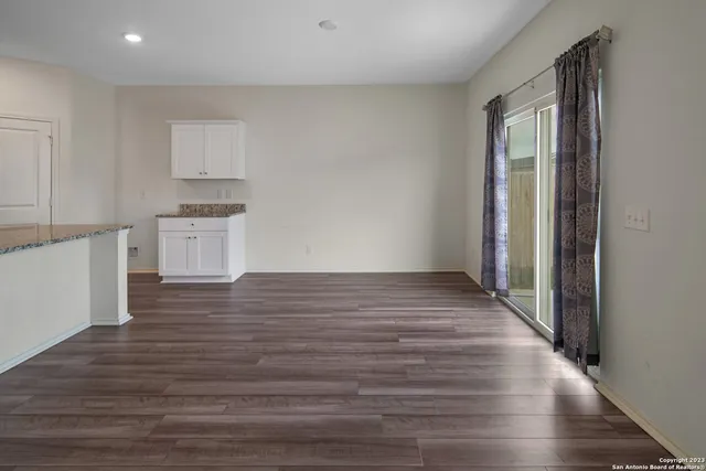 a view of a kitchen with wooden floor and a sink