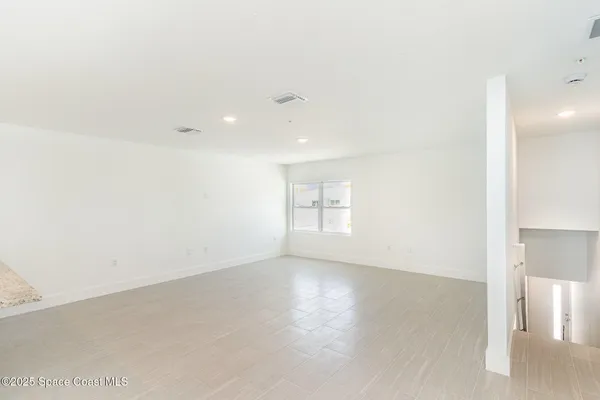 an empty room with windows and entrance