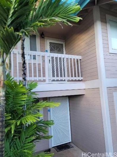 a view of a house with a window and wooden fence