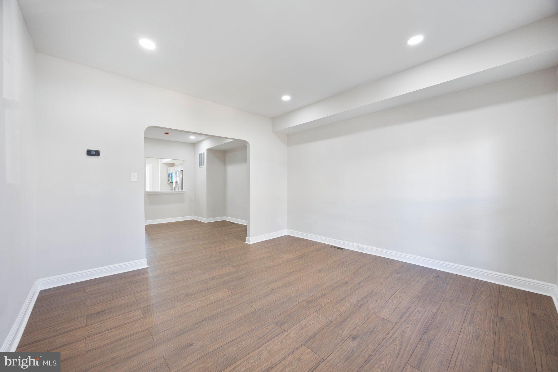117 Collins Avenue Baltimore, MD 21229 - Photo 2 of 27 a view of an empty room with wooden floor