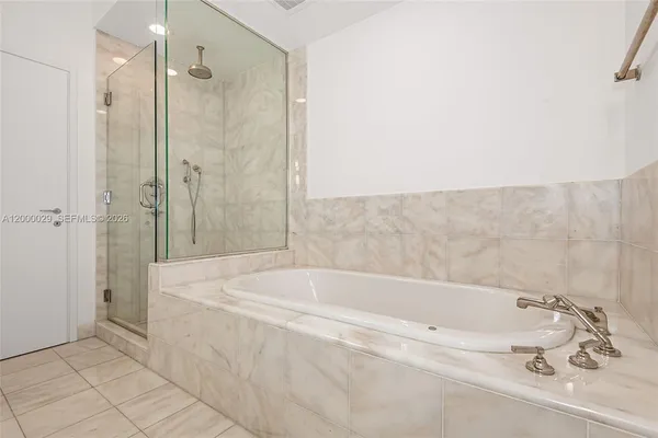 a bathroom with a bathtub and shower