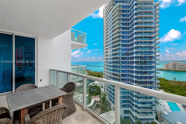 a roof deck with table and chairs