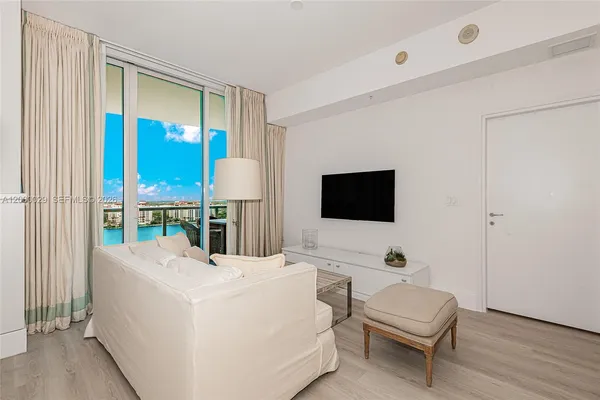 a bed room with a bed and a television