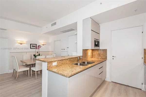 a kitchen with a stove a table and chairs