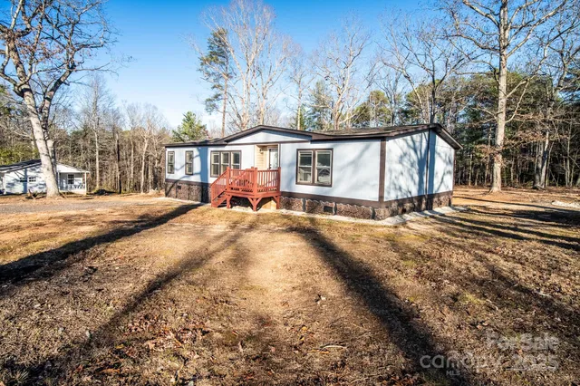 a front view of a house with a yard covered with snow