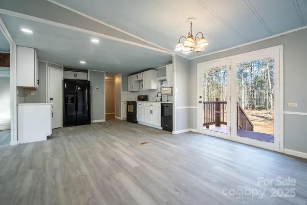 a view of empty room with wooden floor and fireplace