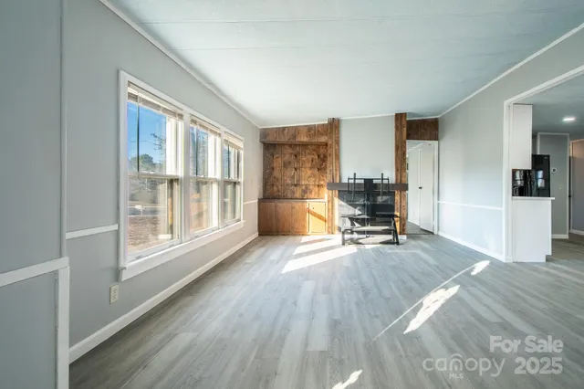 a view of a kitchen with a sink and a refrigerator