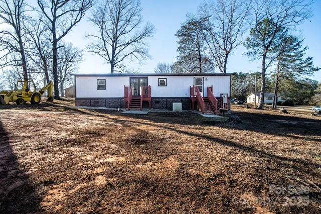a view of a house with a yard covered in snow