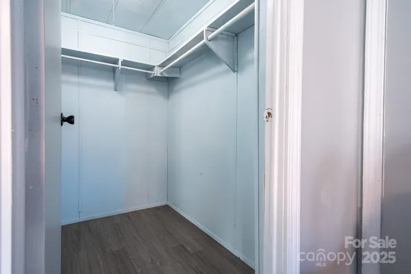 a room with a sink and wooden floor