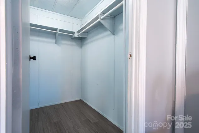 a room with a sink and wooden floor