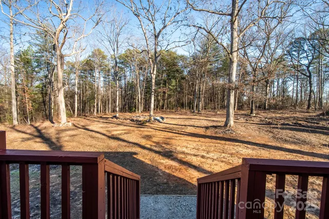 a view of a backyard with wooden fence
