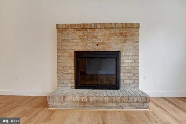 a stone fireplace with wooden floor