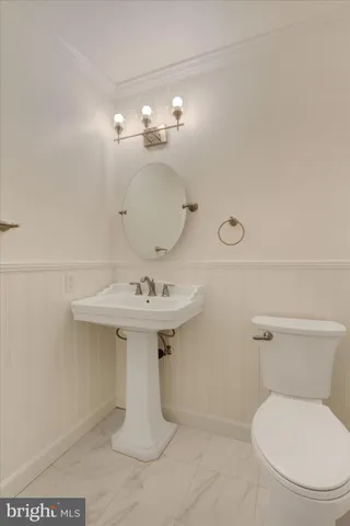 a bathroom with a sink toilet and mirror