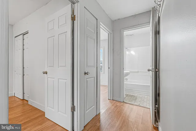 a view of a hallway with wooden floor