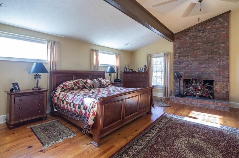 1249 Little Mountain Road Dawsonville, GA 30534 - Photo 13 of 40 a bedroom with a bed and a fireplace