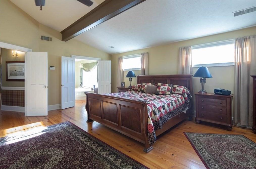 1249 Little Mountain Road Dawsonville, GA 30534 - Photo 14 of 40 a bedroom with a bed and wooden floor