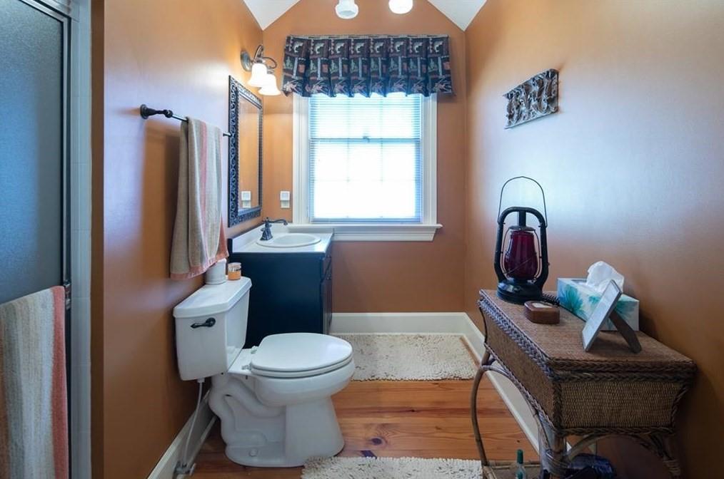 1249 Little Mountain Road Dawsonville, GA 30534 - Photo 16 of 40 a bathroom with a sink toilet and mirror