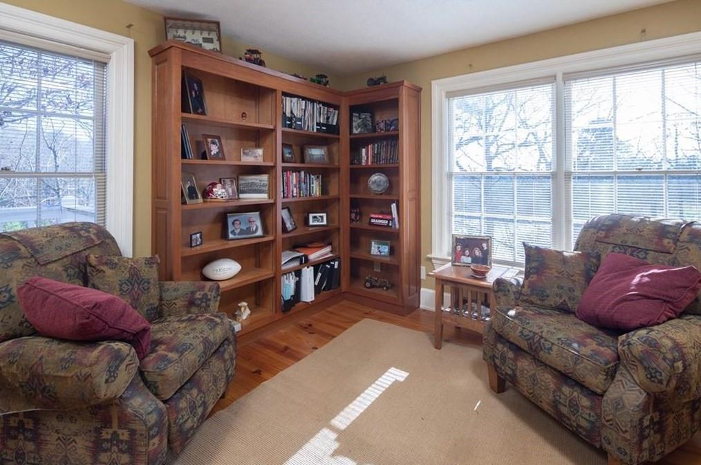 1249 Little Mountain Road Dawsonville, GA 30534 - Photo 17 of 40 a living room with furniture a bookshelf and a large window