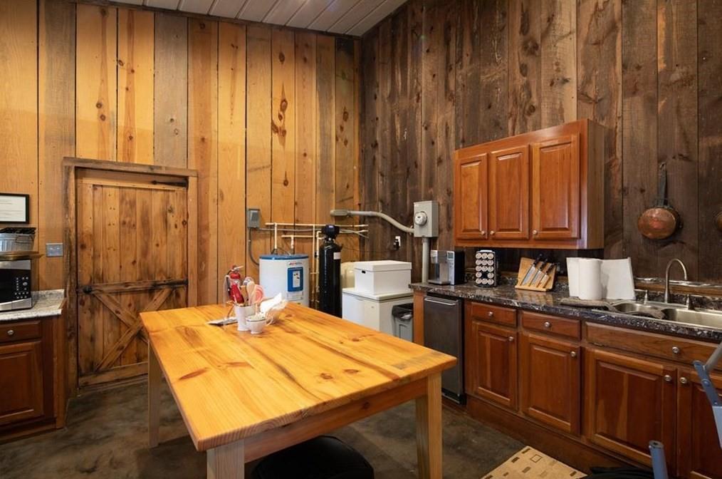 1249 Little Mountain Road Dawsonville, GA 30534 - Photo 33 of 40 a dining room with kitchen island granite countertop wooden floor and stainless steel appliances