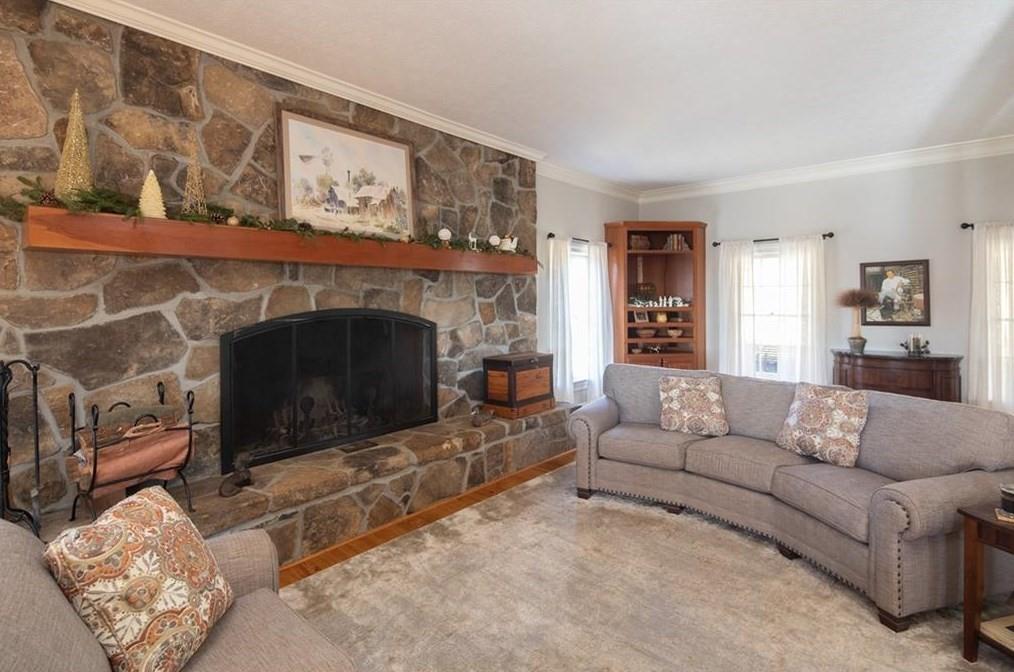 1249 Little Mountain Road Dawsonville, GA 30534 - Photo 7 of 40 a living room with furniture a flat screen tv and a fireplace