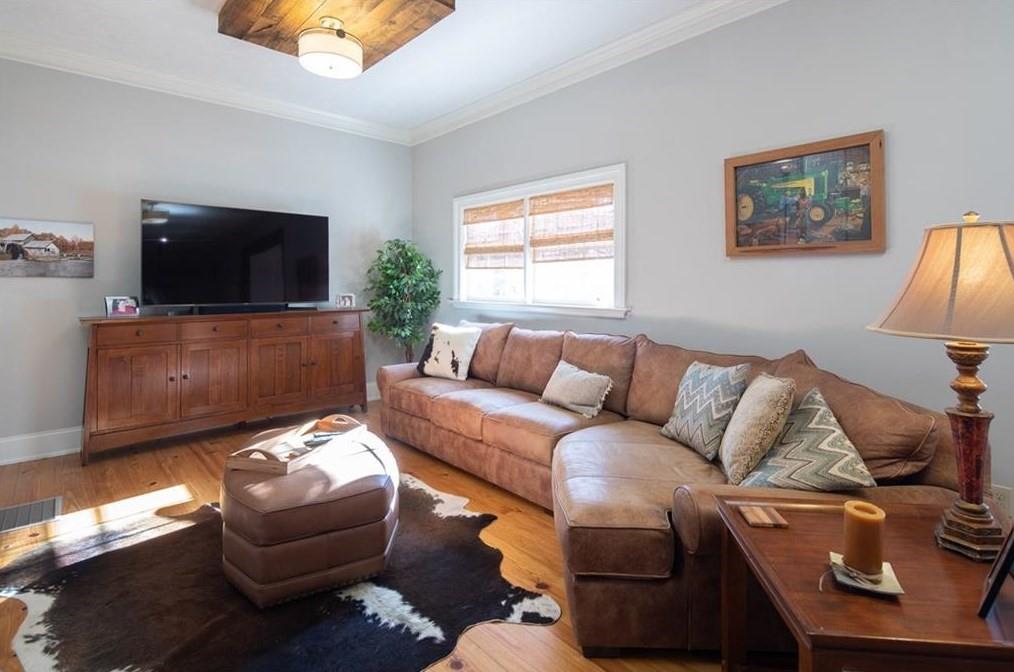 1249 Little Mountain Road Dawsonville, GA 30534 - Photo 10 of 40 a living room with furniture and a flat screen tv